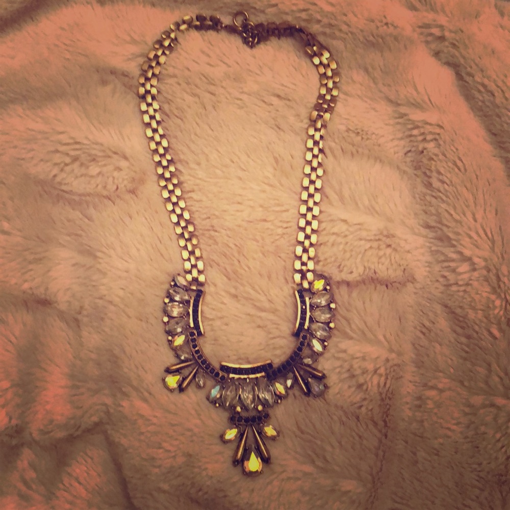 Gold tone collar necklace with clear stones.